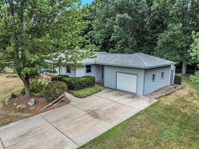 1200 Elmwood Dr, Jenison, MI 49428 - ranch-style house featuring an attached garage, driveway, a shingled roof, and a front yard