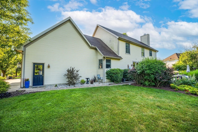 9095 Marsh Cir, Galesburg, MI 49053 - back of property featuring a chimney and a lawn