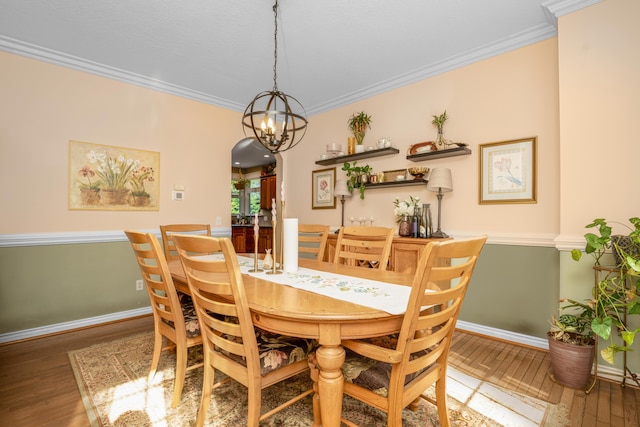 9095 Marsh Cir, Galesburg, MI 49053 - dining area featuring hardwood / wood-style floors, ornamental molding, a chandelier, and arched walkways