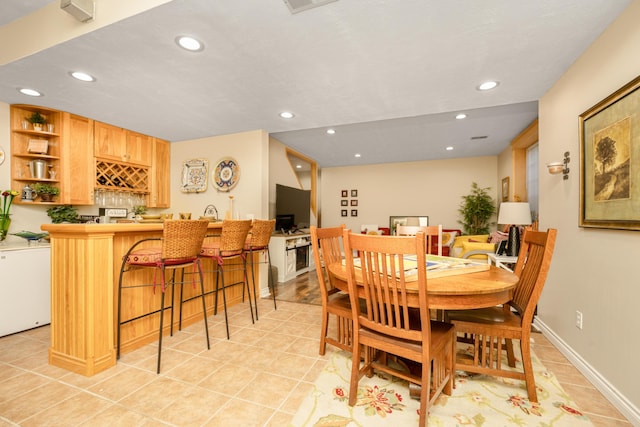 9095 Marsh Cir, Galesburg, MI 49053 - dining space with bar with sink, light tile patterned flooring, and recessed lighting