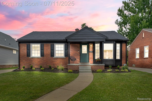 4607 Robinwood Ave, Royal Oak, MI 48073 - bungalow with brick siding, a lawn, and a chimney