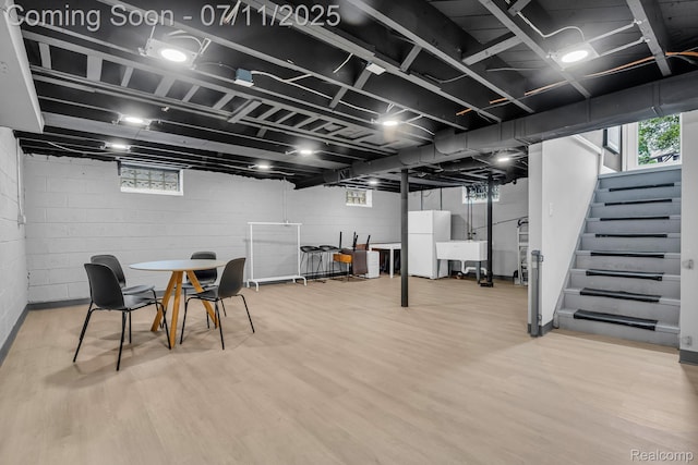 4607 Robinwood Ave, Royal Oak, MI 48073 - basement featuring freestanding refrigerator, stairs, wood finished floors, and healthy amount of natural light