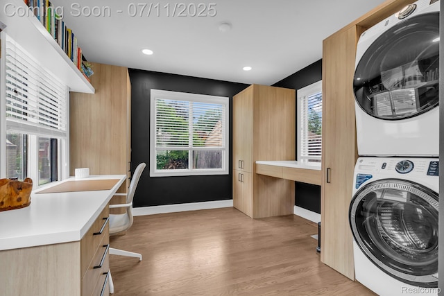 4607 Robinwood Ave, Royal Oak, MI 48073 - laundry area featuring stacked washer / dryer, light wood-style floors, plenty of natural light, cabinet space, and recessed lighting