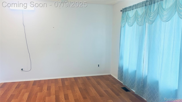 4224 Garrick Ave, Sterling Heights, MI 48091 - unfurnished room featuring dark wood-type flooring and baseboards