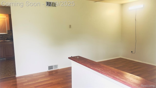 4224 Garrick Ave, Sterling Heights, MI 48091 - hallway featuring dark wood-style floors and a sink