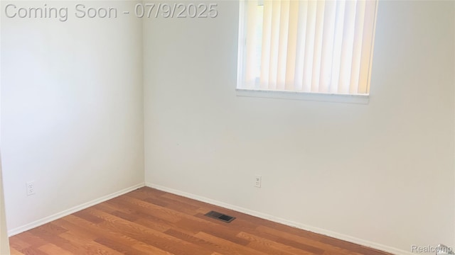 4224 Garrick Ave, Sterling Heights, MI 48091 - empty room with wood finished floors and baseboards