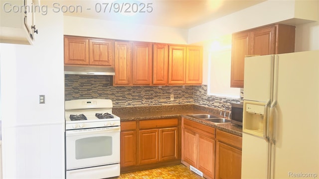 4224 Garrick Ave, Sterling Heights, MI 48091 - kitchen featuring white appliances, under cabinet range hood, dark countertops, tasteful backsplash, and wainscoting