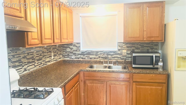 4224 Garrick Ave, Sterling Heights, MI 48091 - kitchen with white appliances, under cabinet range hood, dark countertops, and decorative backsplash