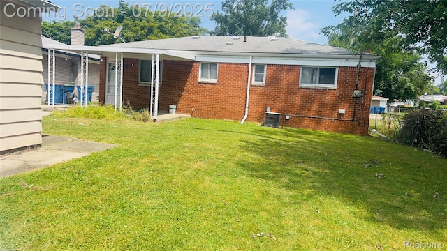 4224 Garrick Ave, Sterling Heights, MI 48091 - rear view of property featuring brick siding and a chimney