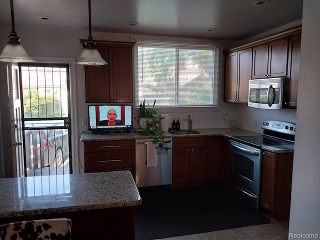 16834 Muirland St, Detroit, MI 48221 - kitchen featuring stainless steel appliances, hanging light fixtures, and light stone countertops