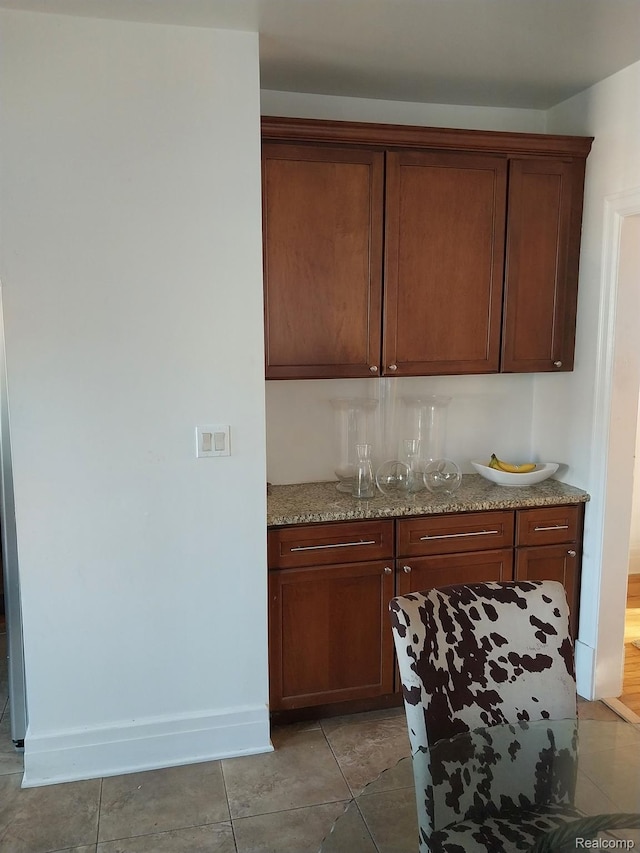 16834 Muirland St, Detroit, MI 48221 - kitchen featuring light stone counters and light tile patterned floors