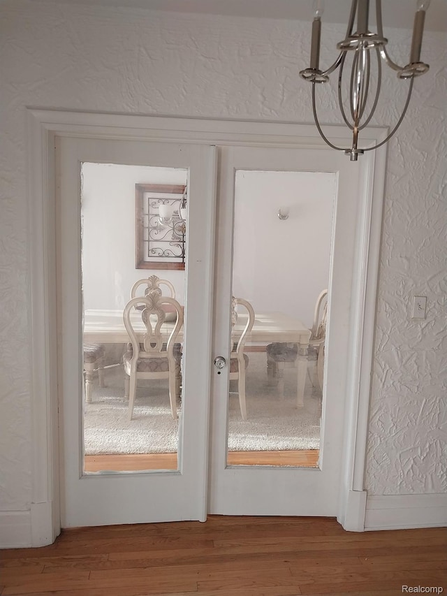16834 Muirland St, Detroit, MI 48221 - detailed view of a textured wall, wood finished floors, and a chandelier