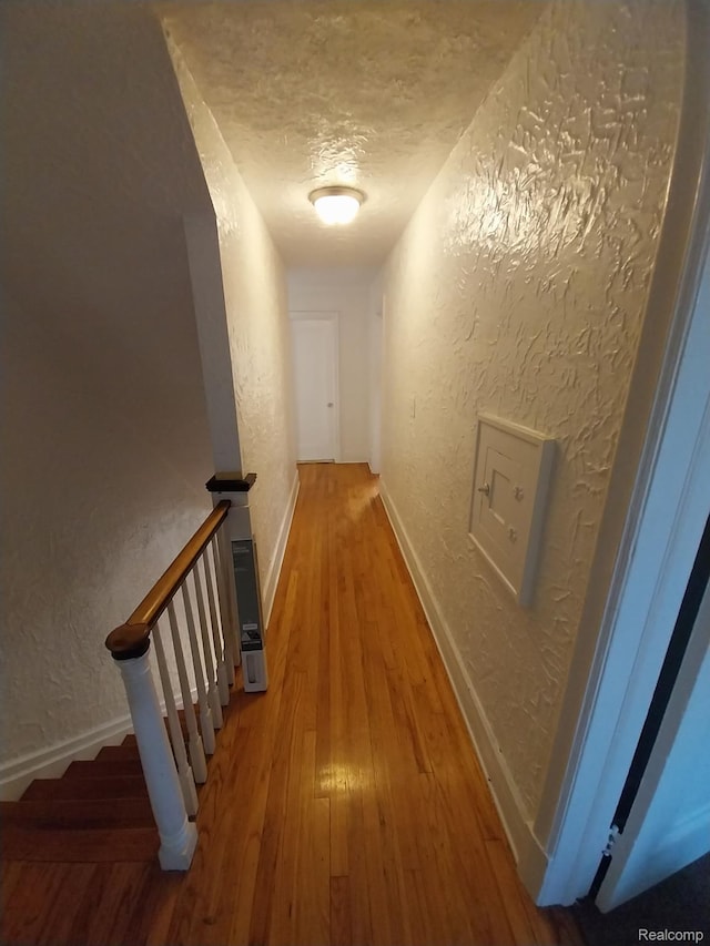 16834 Muirland St, Detroit, MI 48221 - hall featuring a textured wall, hardwood / wood-style flooring, and a textured ceiling