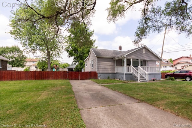 29046 S Wesley Ave, Flat Rock, MI 48134 - view of front facade featuring covered porch, a chimney, and concrete driveway
