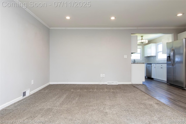 29046 S Wesley Ave, Flat Rock, MI 48134 - unfurnished living room with crown molding, dark colored carpet, and recessed lighting