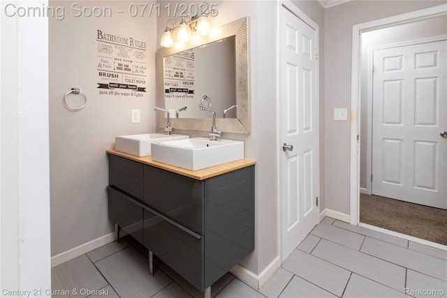 29046 S Wesley Ave, Flat Rock, MI 48134 - bathroom with double vanity and baseboards