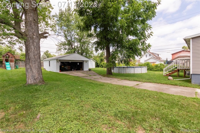 29046 S Wesley Ave, Flat Rock, MI 48134 - view of yard with an outdoor structure, a garage, and an outdoor pool