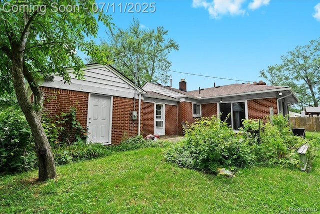 21840 N Tuller Ct, Southfield, MI 48076 - back of property featuring brick siding and a chimney