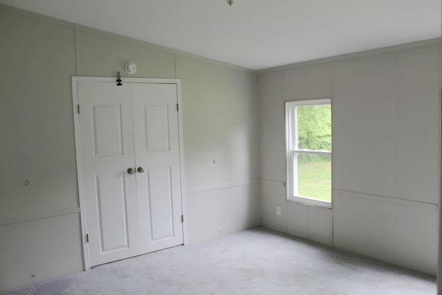 5249 Lapeer Rd, Burton, MI 48509 - unfurnished bedroom with carpet floors, a closet, and crown molding