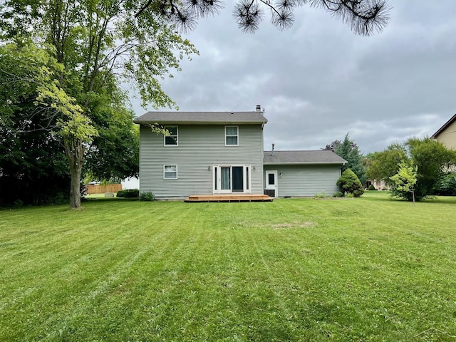 4865 Cactus Dr, Saginaw, MI 48603 - rear view of property with a deck, a lawn, and a chimney