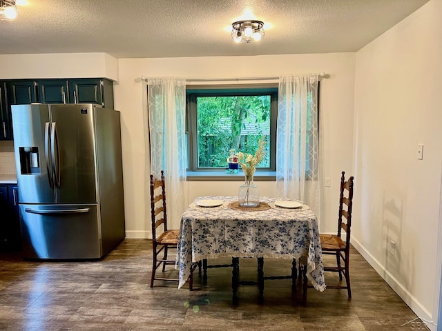 4865 Cactus Dr, Saginaw, MI 48603 - dining space featuring dark wood-type flooring and a textured ceiling