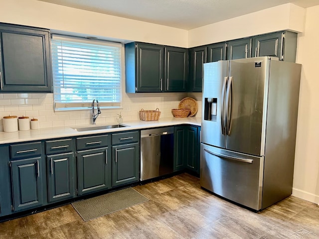 4865 Cactus Dr, Saginaw, MI 48603 - kitchen featuring stainless steel appliances, wood finished floors, light countertops, and tasteful backsplash
