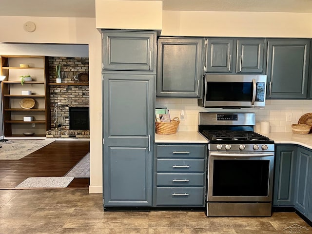 4865 Cactus Dr, Saginaw, MI 48603 - kitchen featuring stainless steel appliances, light countertops, decorative backsplash, and gray cabinets