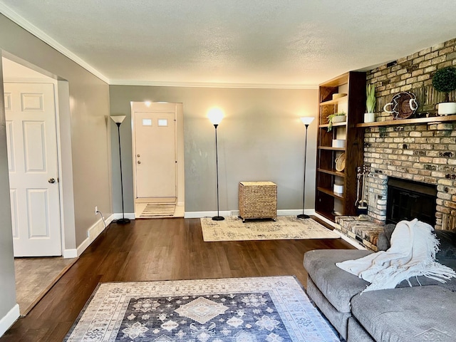 4865 Cactus Dr, Saginaw, MI 48603 - living area with wood finished floors, a brick fireplace, crown molding, and a textured ceiling