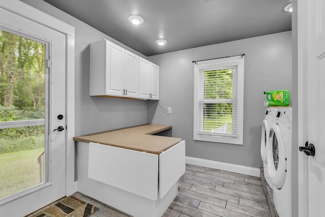 4825 Walz Rd, Jackson, MI 49201 - laundry room featuring independent washer and dryer, cabinet space, and light wood-style floors