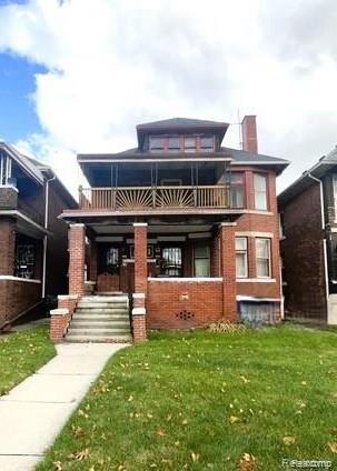2471-2473 Lothrop St, Detroit, MI 48206 - view of front of home with a front lawn, brick siding, a chimney, and a balcony