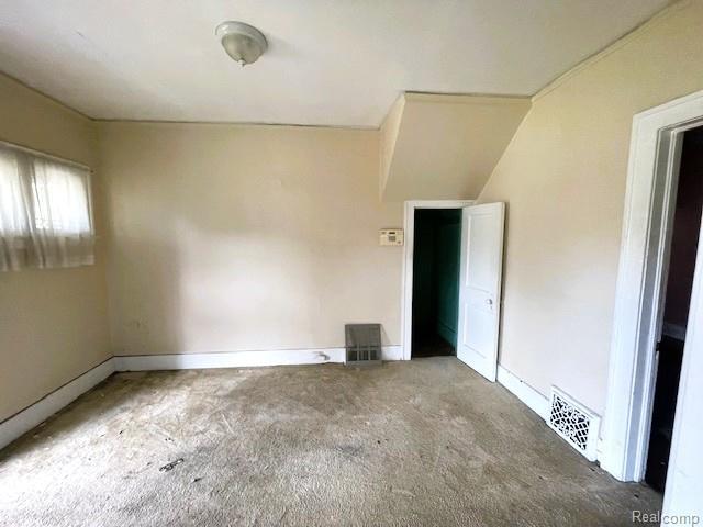 2471-2473 Lothrop St, Detroit, MI 48206 - unfurnished bedroom featuring carpet flooring and baseboards