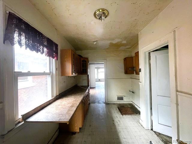 2471-2473 Lothrop St, Detroit, MI 48206 - kitchen featuring brown cabinetry and light flooring