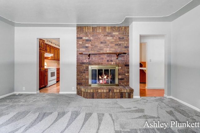 1460 N Peterson Rd, Muskegon, MI 49445 - unfurnished living room featuring light colored carpet and a fireplace