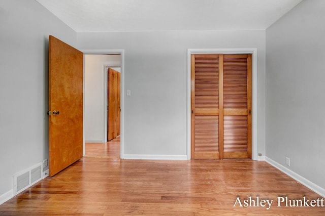 1460 N Peterson Rd, Muskegon, MI 49445 - unfurnished bedroom with a closet and wood finished floors