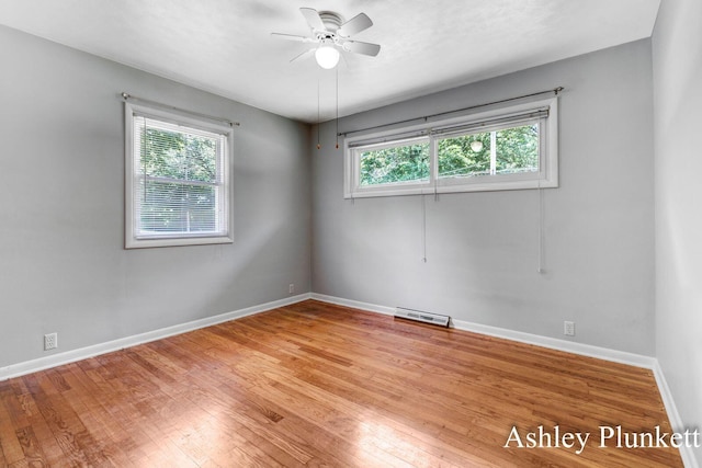 1460 N Peterson Rd, Muskegon, MI 49445 - empty room featuring healthy amount of natural light, ceiling fan, and wood finished floors