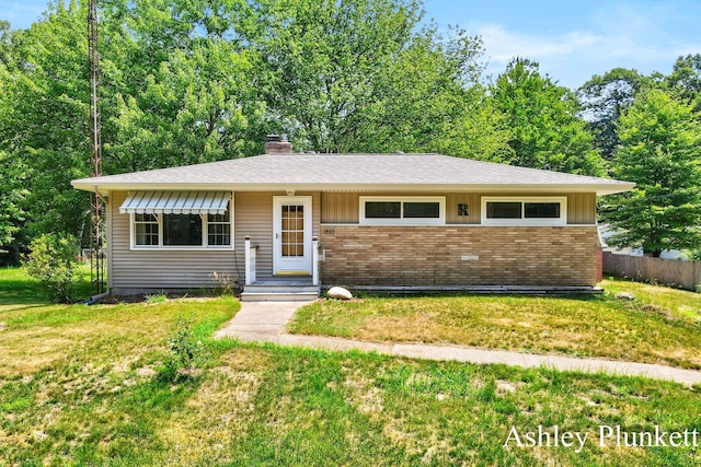 1460 N Peterson Rd, Muskegon, MI 49445 - view of front of home with brick siding and a chimney