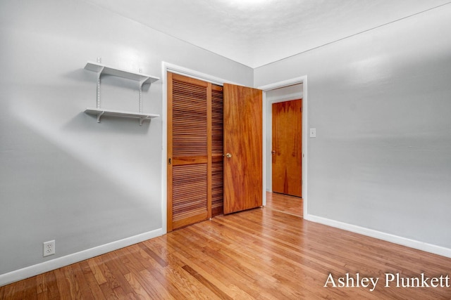1460 N Peterson Rd, Muskegon, MI 49445 - unfurnished bedroom featuring a closet and wood finished floors