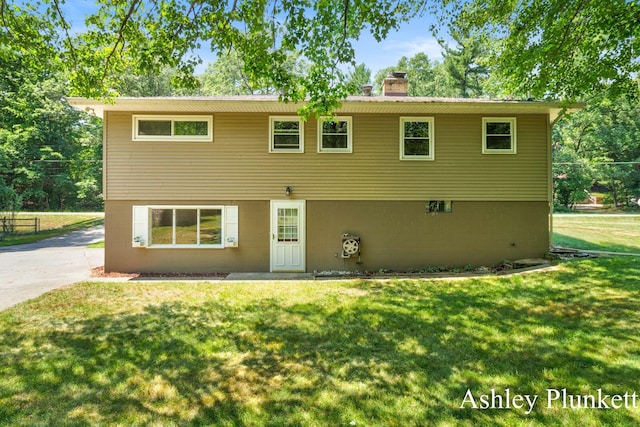 1460 N Peterson Rd, Muskegon, MI 49445 - view of front facade featuring a chimney and a front lawn