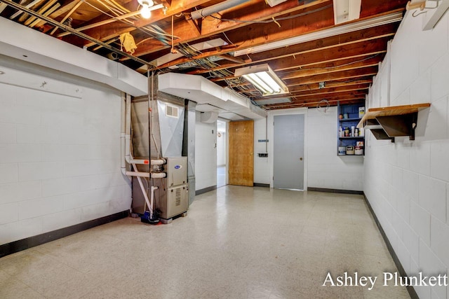 1460 N Peterson Rd, Muskegon, MI 49445 - unfinished basement featuring tile patterned floors, heating unit, and concrete block wall