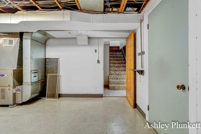 1460 N Peterson Rd, Muskegon, MI 49445 - unfinished basement with tile patterned floors, stairway, and heating unit