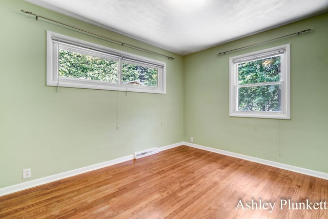 1460 N Peterson Rd, Muskegon, MI 49445 - empty room featuring baseboards and wood finished floors