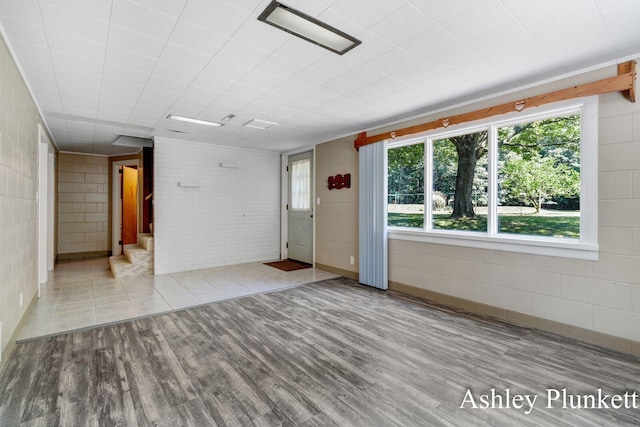1460 N Peterson Rd, Muskegon, MI 49445 - unfurnished room with wood finished floors and concrete block wall