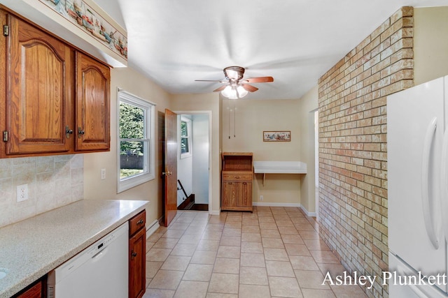 1460 N Peterson Rd, Muskegon, MI 49445 - kitchen with white appliances, ceiling fan, tasteful backsplash, light countertops, and brown cabinetry