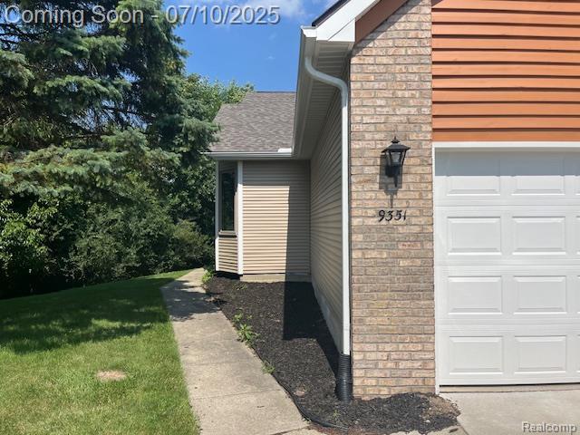 9351 Rayna Dr, Davison, MI 48423 - entrance to property featuring brick siding, a lawn, and a shingled roof