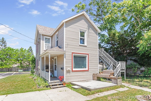 1002 Madison St, Grand Haven, MI 49417 - view of front of house with roof with shingles, a front lawn, stairs, and a porch