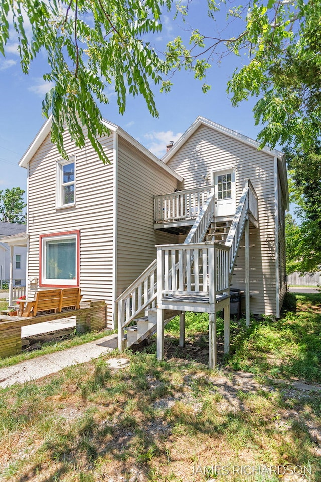 1002 Madison St, Grand Haven, MI 49417 - rear view of house with stairs and a wooden deck