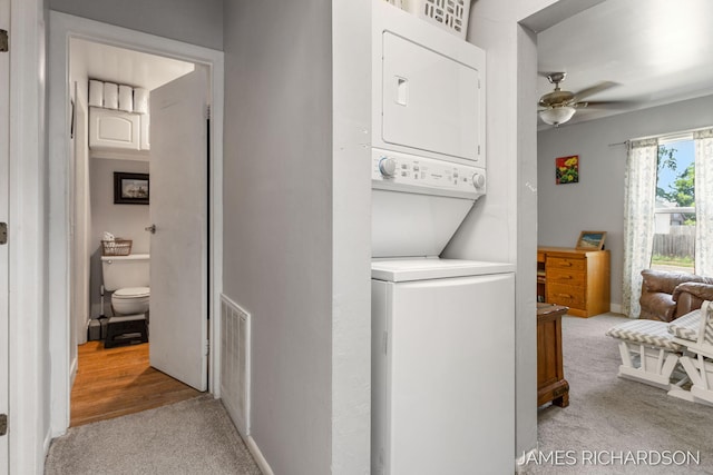 1002 Madison St, Grand Haven, MI 49417 - laundry room with stacked washer / drying machine, light colored carpet, and a ceiling fan