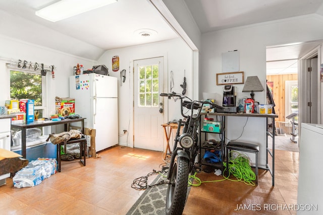 1002 Madison St, Grand Haven, MI 49417 - kitchen featuring freestanding refrigerator, vaulted ceiling, and crown molding