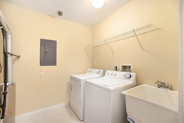 5724 Hampshire Ln, Ypsilanti, MI 48197 - laundry room featuring washer and dryer, electric panel, and light tile patterned floors