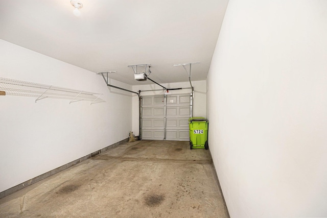 5724 Hampshire Ln, Ypsilanti, MI 48197 - garage featuring a garage door opener and baseboards